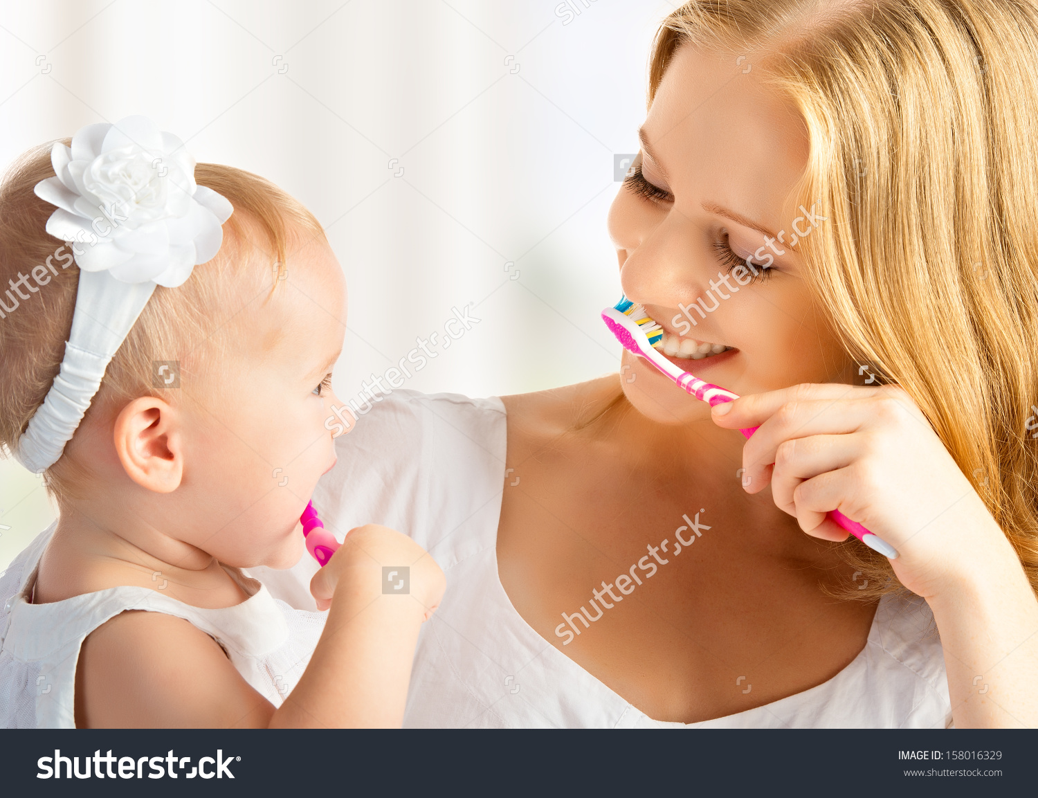 stock-photo-happy-family-and-health-mother-and-daughter-baby-girl-brushing-their-teeth-together-158016329.jpg